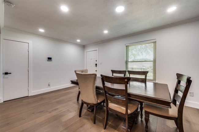Dining room with crown molding, wood-type flooring, and recessed lighting | Image 6