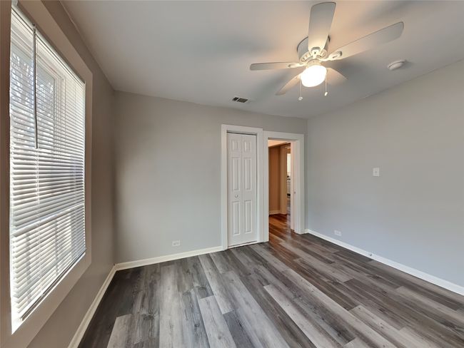 Unfurnished bedroom featuring baseboards, dark wood finished floors, a closet, and ceiling fan | Image 6