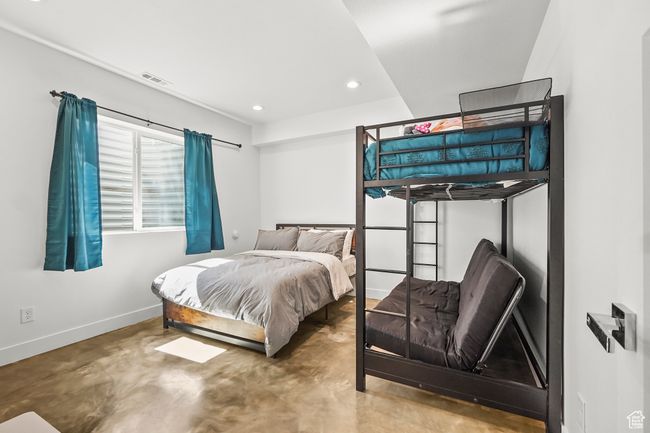 Bedroom with concrete flooring and recessed lighting | Image 30