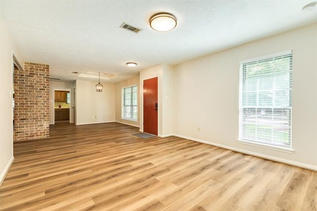 At the front of the home sits the formal living & dining room -- plenty of space to entertain family & friends. LVP throughout the living spaces of the home. Kitchen is at the back of the photo. | Image 5