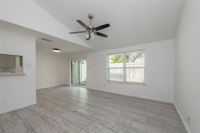 Spare room with high vaulted ceiling, visible vents, baseboards, and ceiling fan | Image 6