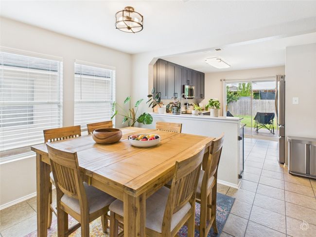 Dining area featuring baseboards and light tile patterned floors | Image 7