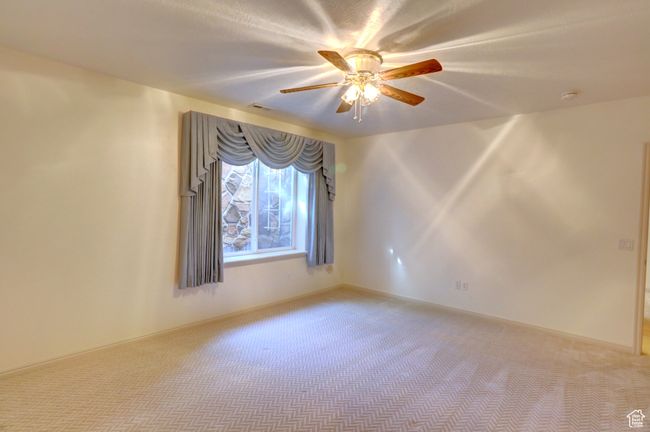 Spare room with a ceiling fan and carpet | Image 34