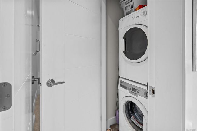 Laundry area with stacked washing machine and dryer | Image 47