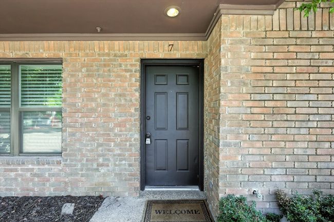 View of exterior entry with brick siding | Image 5
