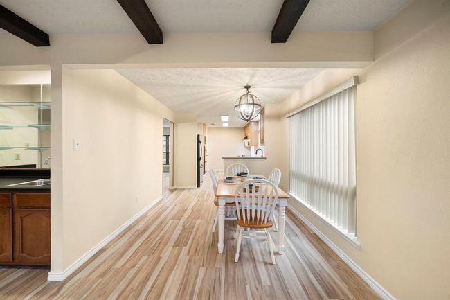 The breakfast area sits adjacent to the kitchen and living room. | Image 13