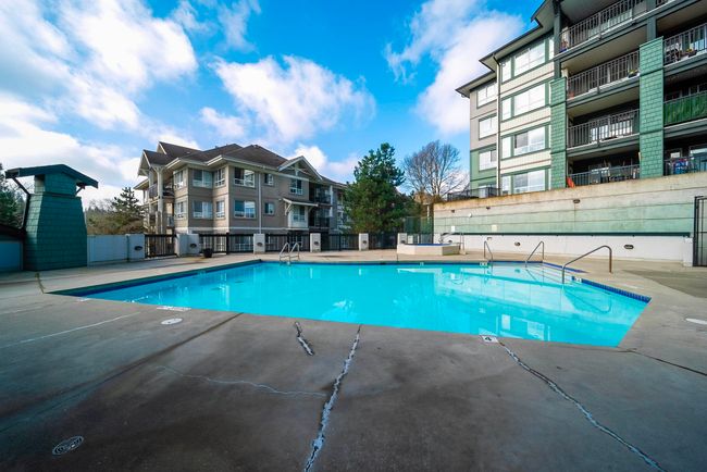 Community pool with fence and a patio | Image 34