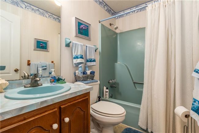 Guest bathroom featuring shower / bath combo, vanity, and toilet | Image 31