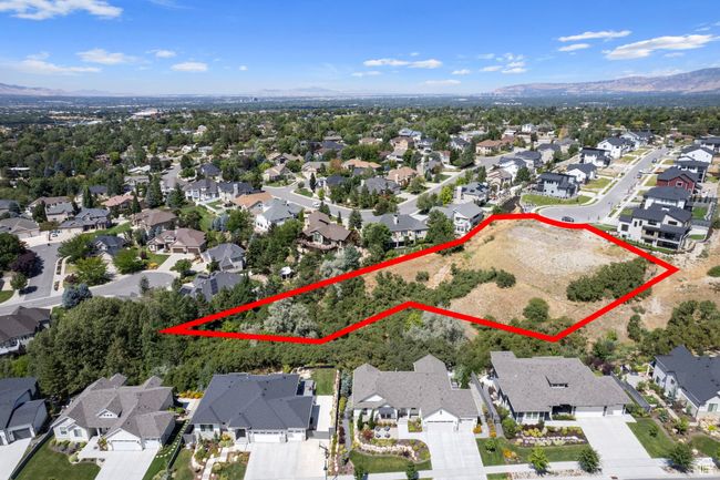 Aerial view of residential area with mountains and property parcel outlined | Image 44