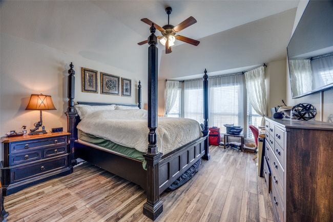 Bedroom featuring ceiling fan, lofted ceiling, and light wood-type flooring | Image 13