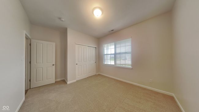 unfurnished bedroom featuring baseboards, visible vents, a closet, and light colored carpet | Image 13