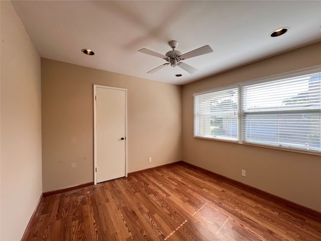 Empty room with wood finished floors and ceiling fan | Image 8