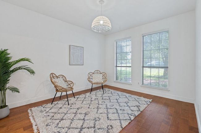 Sitting room with baseboards and wood finished floors | Image 15