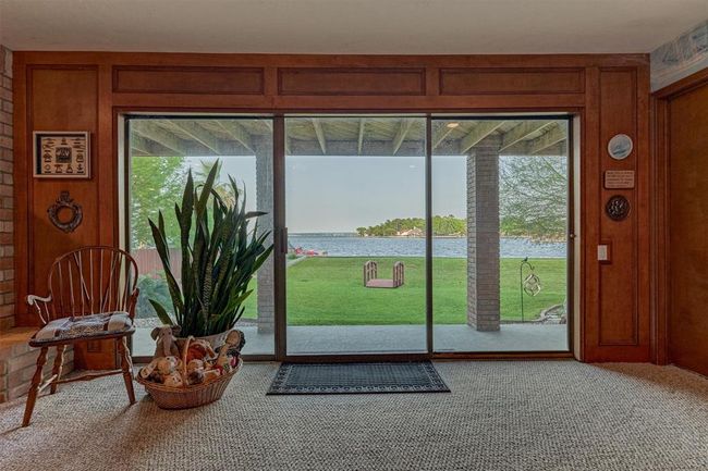 Sliding glass doors from the game room provide easy access to the covered back porch and spacious backyard. | Image 27
