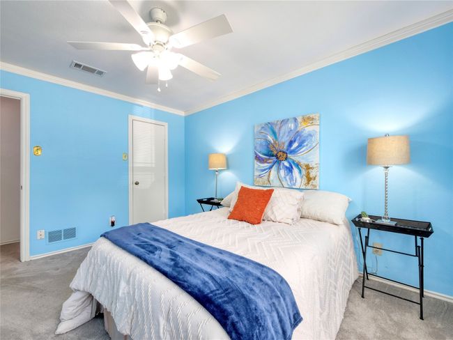 Bedroom with carpet flooring, crown molding, and a ceiling fan | Image 22