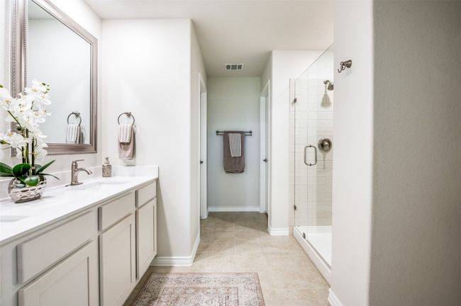Full bathroom featuring double vanity, a stall shower, and tile patterned flooring | Image 23