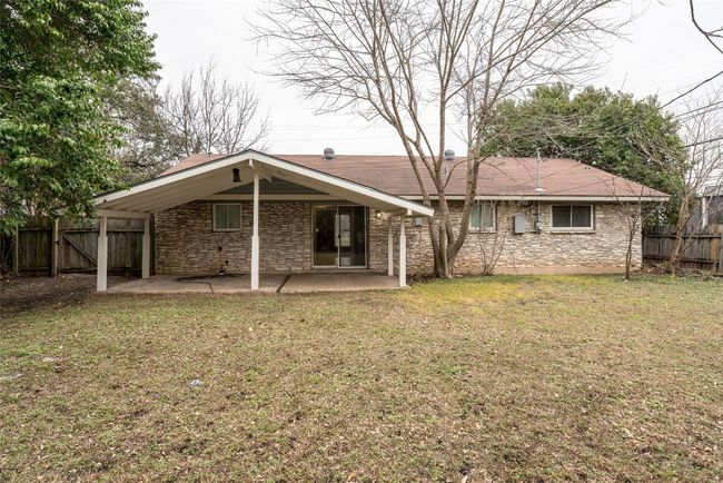 Back of house with a patio and stone siding | Image 5