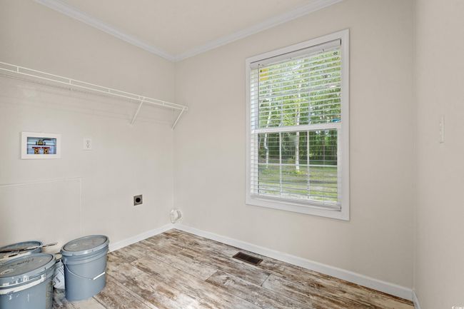 Laundry area with laundry area, hookup for a washing machine, visible vents, wood finished floors, and hookup for an electric dryer | Image 28
