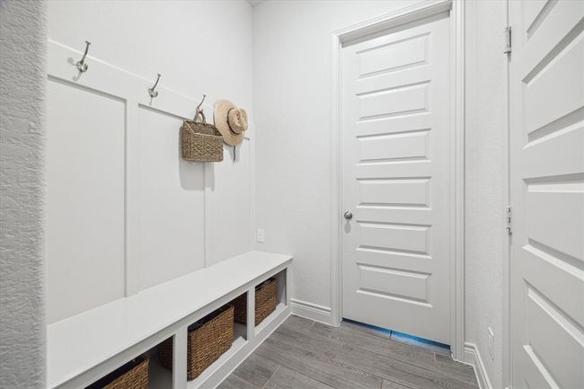 The coveted mud room offers hooks, bins, and a bench, making organization effortless and keeping everyday essentials within easy reach. It is the perfect place to hang bags, coats, and more after a long day, providing a stylish and functional transition from outdoors to home. | Image 27
