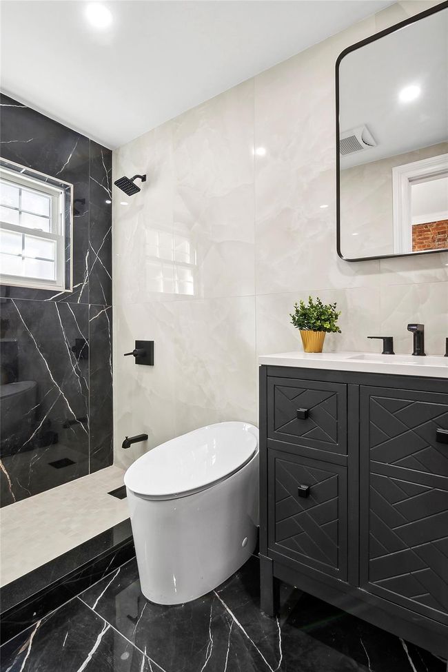 Bathroom with marble tiled floors, a marble finish shower, vanity, tile walls, and recessed lighting | Image 7