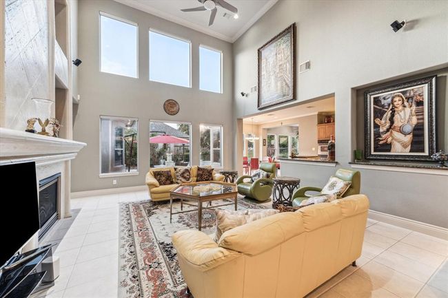 Captured in this image is the main Living Area which measures 20' x 17. You will notice the double volume windows that overlook the rear oasis in the foreground. | Image 7