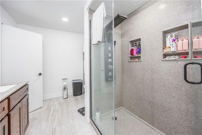 Full bath featuring vanity, recessed lighting, a stall shower, and baseboards | Image 15