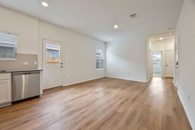 Unfurnished living room featuring healthy amount of natural light, light wood-type flooring, and recessed lighting | Image 8