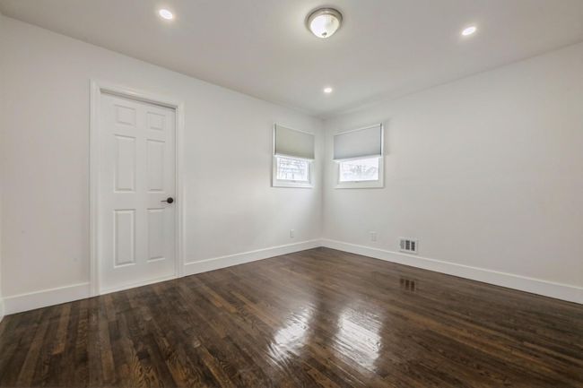 Unfurnished room featuring visible vents, baseboards, and dark wood-style floors | Image 8