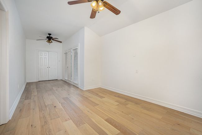 Empty room with baseboards, a ceiling fan, and light wood finished floors | Image 14