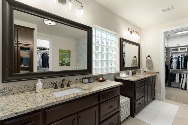 Primary Bathroom featuring two vanities and 2 Custom walk in closets. | Image 20