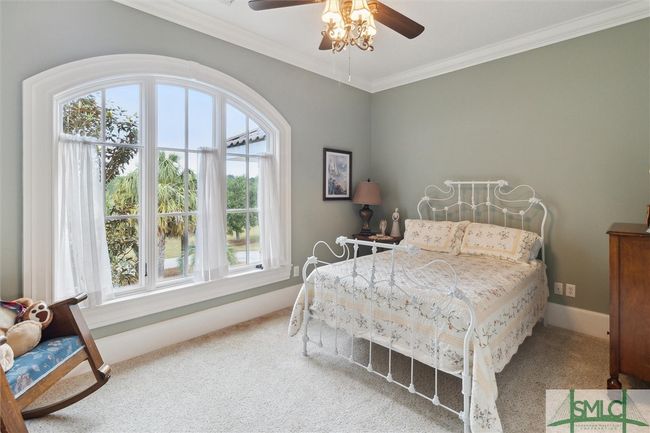 Bedroom 2 is facing the front of the home with a pond view. | Image 32