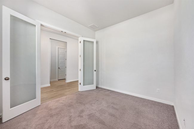 Home office featuring carpet flooring and French doors, with plenty of natural light | Image 5
