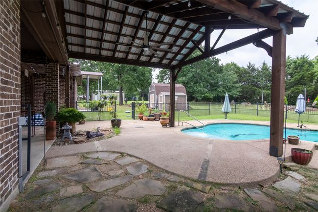 View of pool featuring a patio area and a ceiling fan | Image 31