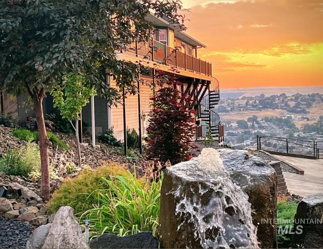 View of side of home featuring stairs and a wooden deck | Image 4