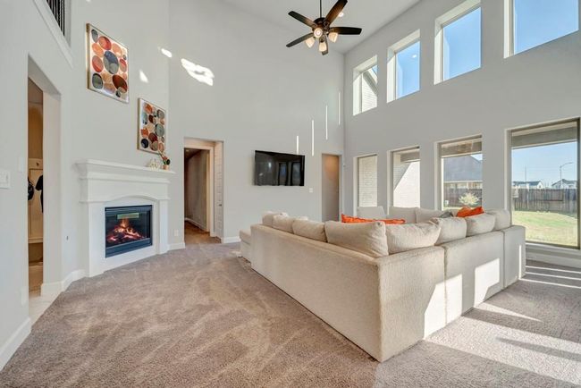 The primary suite and second bedroom with ensuite bath are located off this great room. Doorway to the left leads to the mudroom, laundry, half bath and garage access. | Image 10
