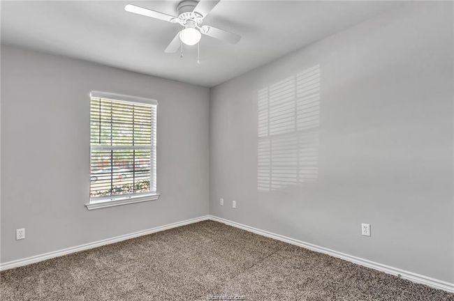 Carpeted spare room with plenty of natural light and a ceiling fan | Image 11