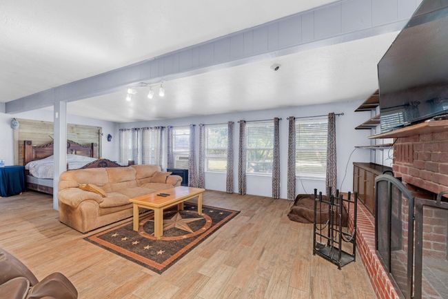 Living room featuring wood finished floors and a fireplace | Image 15