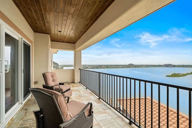 The third-level terrace, accessible from the game/media room, provides a peaceful retreat with panoramic waterfront views | Image 32