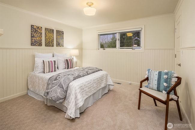 Custom painted beadboard in all of its glory gives this bedroom character galore. | Image 21
