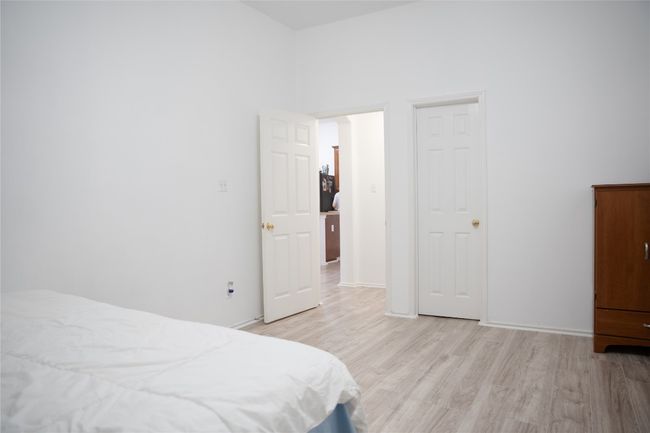 Bedroom with light wood finished floors | Image 15