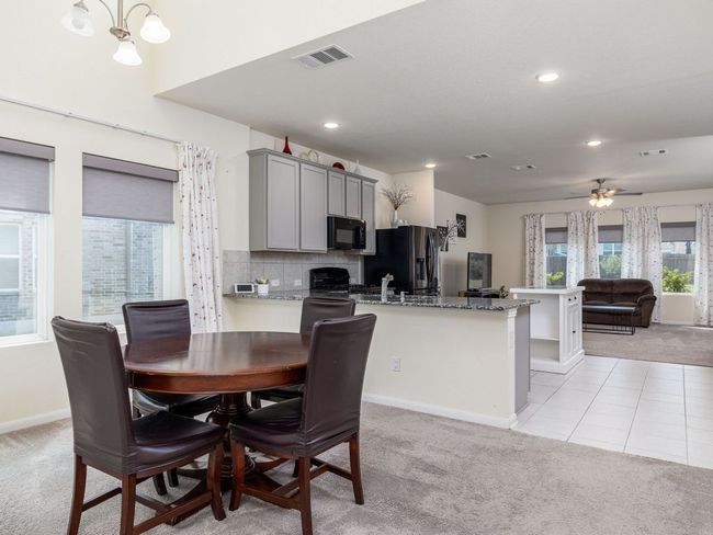 Dining area with light colored carpet, baseboards, recessed lighting, and a ceiling fan | Image 6