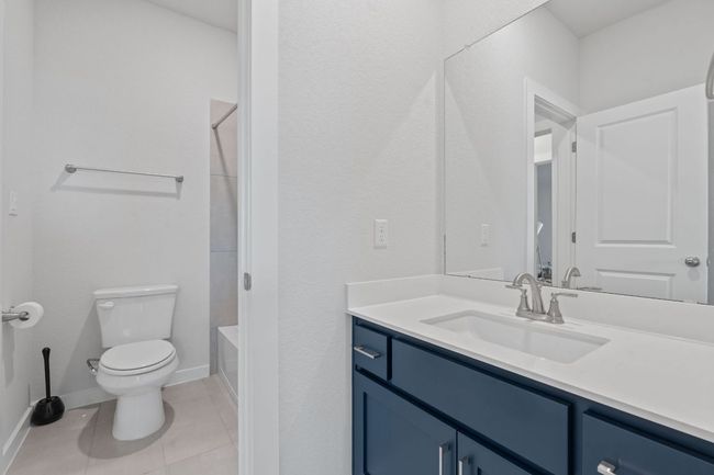 Full bath with toilet, vanity, tile patterned floors, and baseboards | Image 21