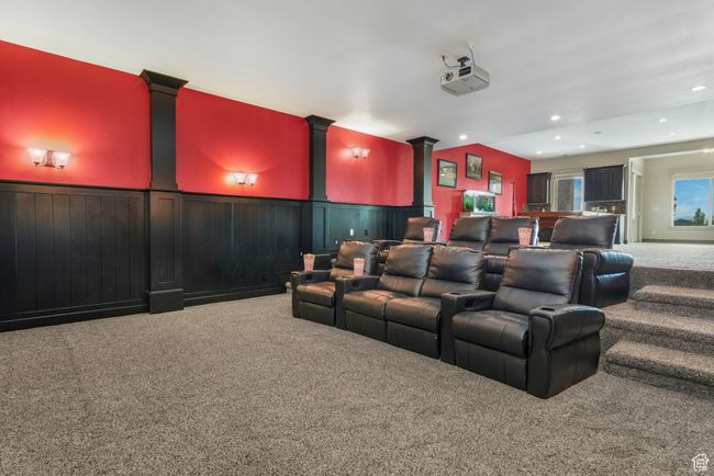 Cinema with a wainscoted wall, carpet flooring, and recessed lighting | Image 14