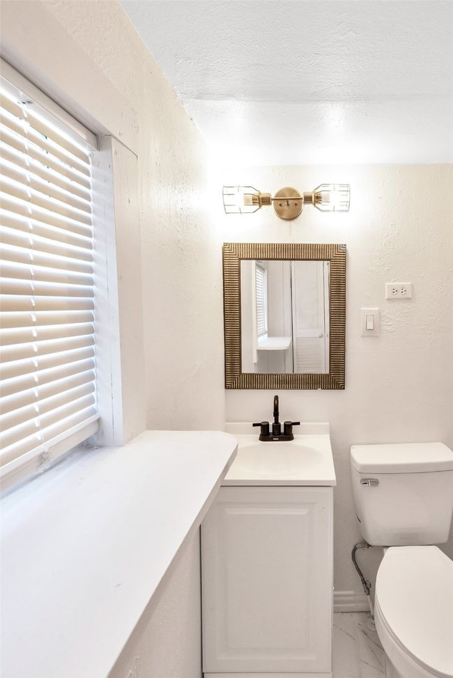 Half bath with marble finish floors, vanity, a textured wall, and a textured ceiling | Image 19