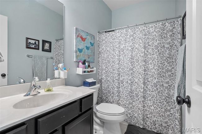 Bathroom featuring vanity and a shower with curtain | Image 22