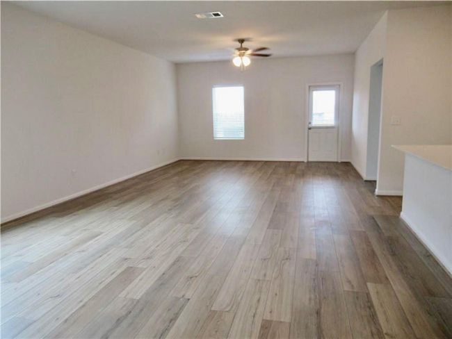 Spare room featuring ceiling fan and wood finished floors | Image 7