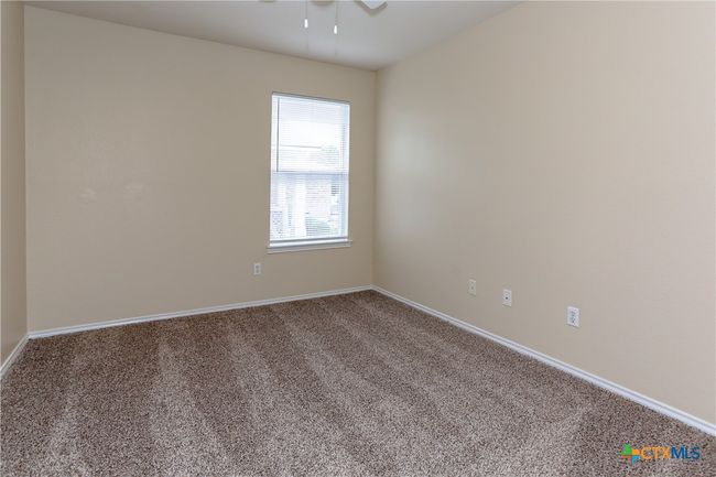 Third bedroom with window and ceiling fan and new carpet. | Image 28