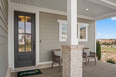 A covered front porch welcomes guests and is a good hang-out spot for Halloween! This photo is for informational purposes only. | Image 3