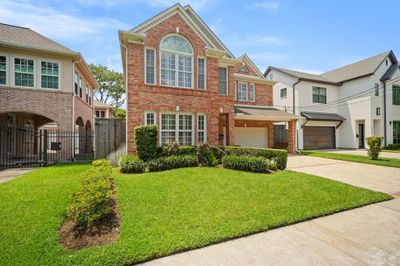 This Timeless Traditional Style House features a Landscaped Front Yard, Manicured Garden Beds, Outdoor Landscape Lighting, and a Sprinkler System. Additional Exterior Amenities include Gutters & Downspouts and a Mosquito Misting System. The Property is zoned to West University Elementary, Pershing Middle School, and Lamar High School. | Image 2