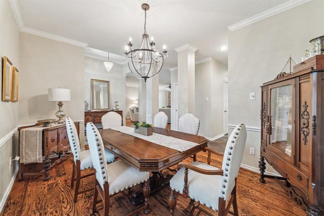 Experience the elegance of hardwood floors and stylish plantation shutters throughout this home. | Image 7